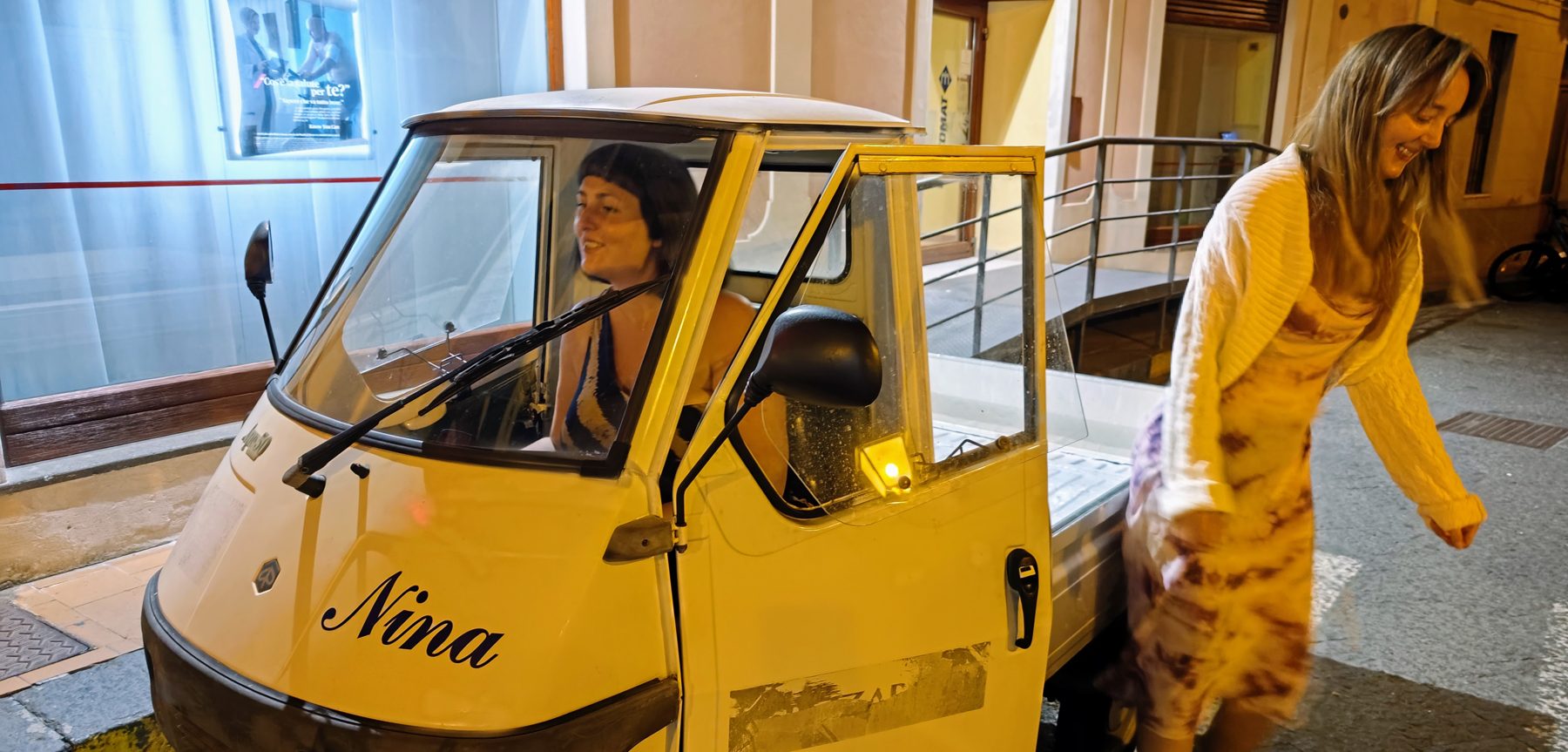 A Piaggio Ape named Nina at night in a Sicilian alley